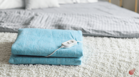 Blue Heating Pad on a White Bed